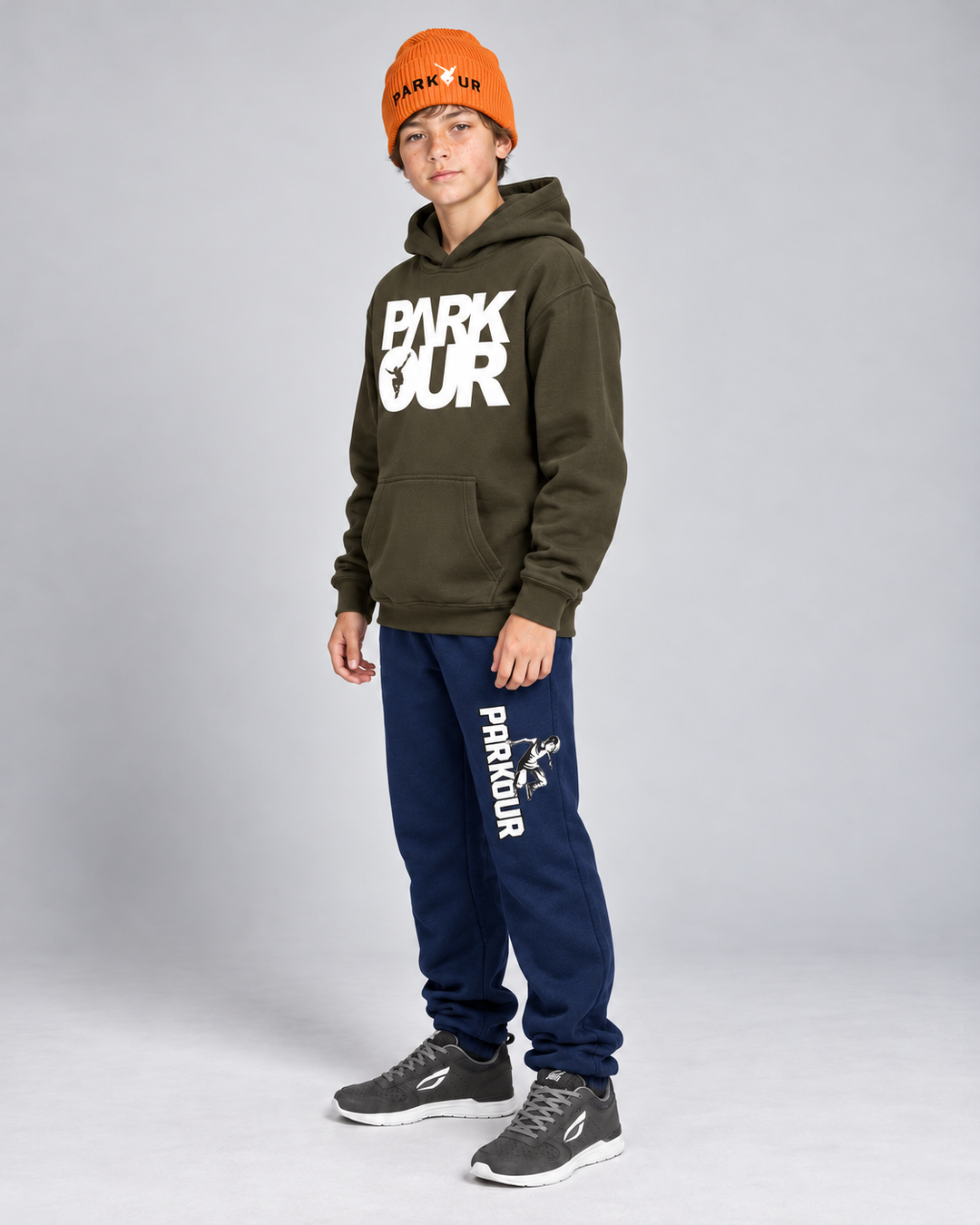 Oliven Parkour-hoodie, navy Traceur-bukser og orange Parkour-hue – fra siden.